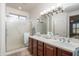 Bathroom with a double sink and a walk-in shower at 21730 N Black Bear Lodge Dr, Surprise, AZ 85387