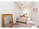 Bedroom with a double bed, mirror and bedside table, lit by natural light and overhead lighting at 21730 N Black Bear Lodge Dr, Surprise, AZ 85387