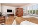 A bedroom with a wooden sauna, a TV, and a bed with a blanket in front of shuttered windows at 21730 N Black Bear Lodge Dr, Surprise, AZ 85387