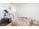 Small workout bedroom with a Spirit Stepper and a bed with a fur blanket at 21730 N Black Bear Lodge Dr, Surprise, AZ 85387
