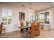 Elegant dining room featuring natural lighting and a sleek glass dining table at 21730 N Black Bear Lodge Dr, Surprise, AZ 85387