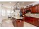 Lovely kitchen with stainless steel appliances, granite counters and large island at 21730 N Black Bear Lodge Dr, Surprise, AZ 85387