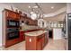 Lovely kitchen with stainless steel appliances, granite counters and large island at 21730 N Black Bear Lodge Dr, Surprise, AZ 85387