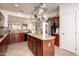 Lovely kitchen with stainless steel appliances, granite counters and large island at 21730 N Black Bear Lodge Dr, Surprise, AZ 85387