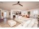 Bright living space with a large sectional sofa and seamless access to the kitchen and dining area at 21730 N Black Bear Lodge Dr, Surprise, AZ 85387