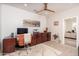 This home office has wood-look floors and a ceiling fan, with a desk, and printer at 21730 N Black Bear Lodge Dr, Surprise, AZ 85387