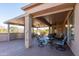 Inviting covered patio with ceiling fans, seating, and views of the surrounding desert landscape at 21730 N Black Bear Lodge Dr, Surprise, AZ 85387