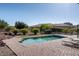 Backyard pool with brick pavers, lounge chairs, and lush landscaping at 21730 N Black Bear Lodge Dr, Surprise, AZ 85387
