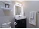 A modern powder room features a black vanity with a white sink and white walls at 2176 E Apollo Ave, Tempe, AZ 85283