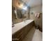 Bathroom with a large mirror, extended vanity, cabinet storage, and neutral accents at 2207 N Shannon Way, Mesa, AZ 85215