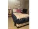 Comfortable bedroom featuring a cozy bed with decorative pillows and a desert-themed art piece at 2207 N Shannon Way, Mesa, AZ 85215