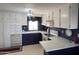 Efficient kitchen layout featuring ample cabinet space, modern appliances, and a bright window above the sink at 2207 N Shannon Way, Mesa, AZ 85215