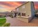 A lovely backyard view featuring an outdoor kitchen and seating area beneath the home's covered patio at 2211 W Desert Ln, Phoenix, AZ 85041