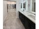 Well-designed bathroom with dual vanity sinks and a spacious walk-in closet at 2212 W Alicia Dr, Phoenix, AZ 85041