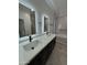 Modern bathroom boasts dual sinks, quartz countertop, soaking tub and beautiful light fixtures at 2212 W Alicia Dr, Phoenix, AZ 85041