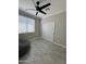 Well-lit bedroom with a ceiling fan, window, and a spacious closet for ample storage at 2212 W Alicia Dr, Phoenix, AZ 85041