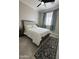 Comfortable bedroom featuring a ceiling fan, rug, window, and an inviting bed at 2212 W Alicia Dr, Phoenix, AZ 85041