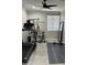 This exercise room boasts a ceiling fan, window, weights, and a treadmill at 2212 W Alicia Dr, Phoenix, AZ 85041
