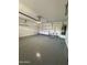 Spacious garage with a sink, white cabinets, and an epoxy floor at 2212 W Alicia Dr, Phoenix, AZ 85041