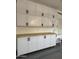 Garage cabinets with light countertops and an adjacent sink at 2212 W Alicia Dr, Phoenix, AZ 85041