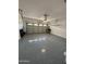 Clean and spacious garage with an epoxy floor, garage door, and automatic door opener at 2212 W Alicia Dr, Phoenix, AZ 85041