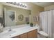 Bathroom featuring a single sink vanity, a large mirror, and a shower-tub combo at 22177 E Calle De Flores --, Queen Creek, AZ 85142