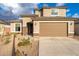 Inviting two-story home with a desert landscaped front yard leading up to its charming neutral stucco exterior and tile roof at 25297 N 163Rd Dr, Surprise, AZ 85387