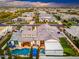 An aerial view of a home with a pool, putting green, outdoor seating, and manicured landscaping at 2656 E Oriole Dr, Gilbert, AZ 85297