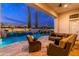 Expansive covered patio featuring comfortable seating, a pool with water features, and lush landscaping for relaxation and entertainment at 2656 E Oriole Dr, Gilbert, AZ 85297