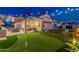 A meticulously landscaped backyard with a putting green, comfortable seating, and an outdoor kitchen under pergola at 2656 E Oriole Dr, Gilbert, AZ 85297