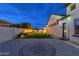 The backyard has a well manicured lawn, custom design on the patio, and comfortable seating at 2656 E Oriole Dr, Gilbert, AZ 85297