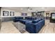 Basement entertainment space with a large sofa, a wet bar, custom built-ins and unique sports memorabilia at 2656 E Oriole Dr, Gilbert, AZ 85297