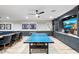 Spacious basement game room with an entertainment area, table tennis and wet bar at 2656 E Oriole Dr, Gilbert, AZ 85297