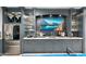 Beautiful basement wet bar with custom cabinets, countertop, shelving, and stainless steel refrigerator at 2656 E Oriole Dr, Gilbert, AZ 85297