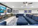 Cozy basement with large sectional sofa, built-in entertainment center, and memorabilia display at 2656 E Oriole Dr, Gilbert, AZ 85297