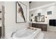 Bright bathroom with marble tub, wood cabinets, and modern fixtures offers luxurious relaxation at 2656 E Oriole Dr, Gilbert, AZ 85297