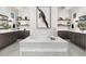 Bright bathroom featuring an island bathtub, stylish floating shelves, and neutral tiling at 2656 E Oriole Dr, Gilbert, AZ 85297