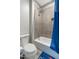 Modern bathroom with a bathtub featuring tile surround and a blue shower curtain at 2656 E Oriole Dr, Gilbert, AZ 85297