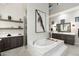 Bathroom featuring an island bathtub, stylish floating shelves, and neutral tiling at 2656 E Oriole Dr, Gilbert, AZ 85297