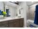 Stylish bathroom with a gray vanity, white countertop, and a bathtub with tiled surround at 2656 E Oriole Dr, Gilbert, AZ 85297