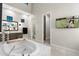 Bright bathroom with soaking tub, wood cabinets, and modern fixtures offers luxurious relaxation at 2656 E Oriole Dr, Gilbert, AZ 85297