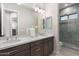 Elegant bathroom with double sink vanity and glass-enclosed shower at 2656 E Oriole Dr, Gilbert, AZ 85297