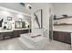 Bright bathroom featuring an island bathtub, stylish floating shelves, and neutral tiling at 2656 E Oriole Dr, Gilbert, AZ 85297