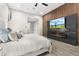 Contemporary bedroom with feature wall, electric fireplace, and large television at 2656 E Oriole Dr, Gilbert, AZ 85297