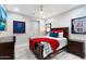 Cozy bedroom featuring sports memorabilia, ceiling fan, and wood-look floors at 2656 E Oriole Dr, Gilbert, AZ 85297