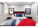 Serene bedroom with sports memorabilia, ceiling fan, and wood-look floors at 2656 E Oriole Dr, Gilbert, AZ 85297