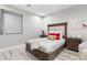 Comfortable bedroom featuring a wood frame bed with a stylish headboard and modern window treatments at 2656 E Oriole Dr, Gilbert, AZ 85297