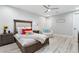 Warm bedroom with a wooden bed frame, ceiling fan, and chair at 2656 E Oriole Dr, Gilbert, AZ 85297