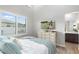 Comfortable bedroom features a bed and shuttered windows, plus easy access to the ensuite bathroom at 2656 E Oriole Dr, Gilbert, AZ 85297