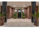 Welcoming entryway featuring detailed woodwork, large potted plants and travertine floors at 2656 E Oriole Dr, Gilbert, AZ 85297